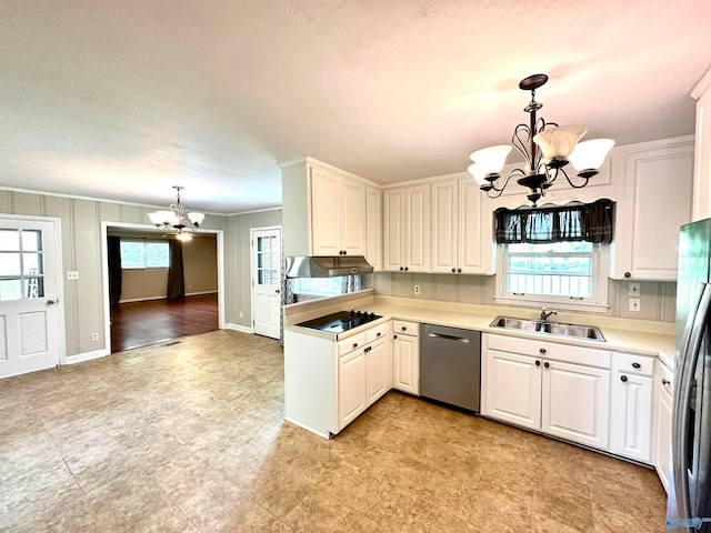 kitchen featuring an inviting chandelier, sink, appliances with stainless steel finishes, and decorative light fixtures