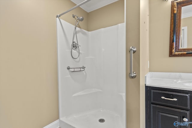 bathroom with a shower, vanity, and crown molding