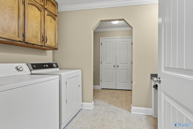 clothes washing area featuring light tile patterned floors, ornamental molding, cabinets, and separate washer and dryer