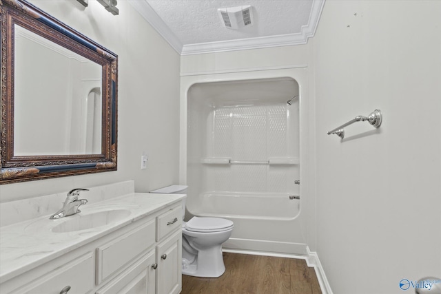 full bathroom featuring a textured ceiling, shower / bathing tub combination, hardwood / wood-style floors, vanity, and toilet