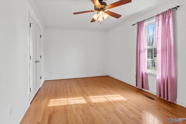 unfurnished room with ceiling fan, light hardwood / wood-style flooring, and crown molding