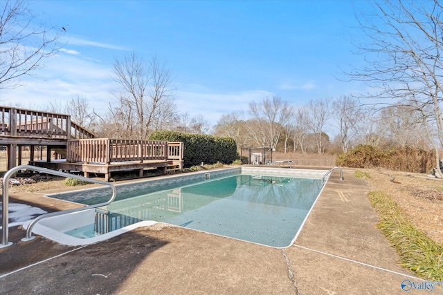 view of swimming pool with a wooden deck