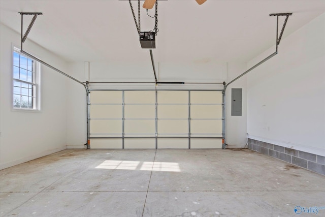 garage with a garage door opener and electric panel