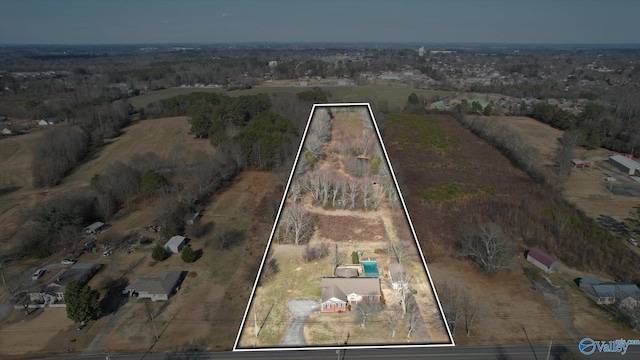 birds eye view of property with a rural view