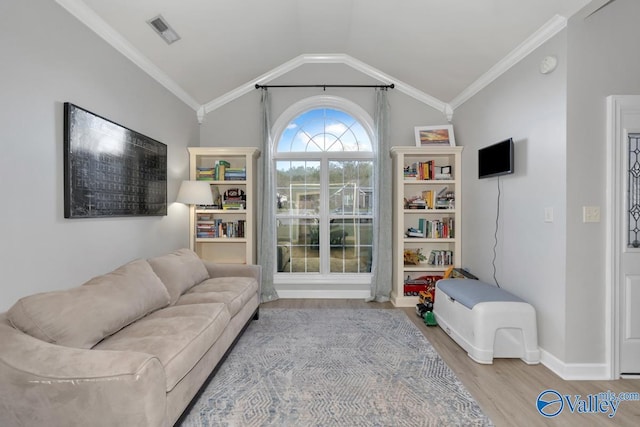 interior space featuring visible vents, ornamental molding, wood finished floors, baseboards, and vaulted ceiling
