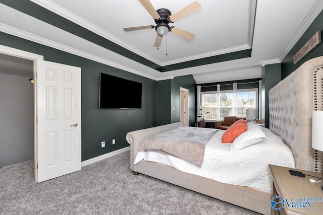 carpeted bedroom featuring ceiling fan, ornamental molding, baseboards, and a raised ceiling