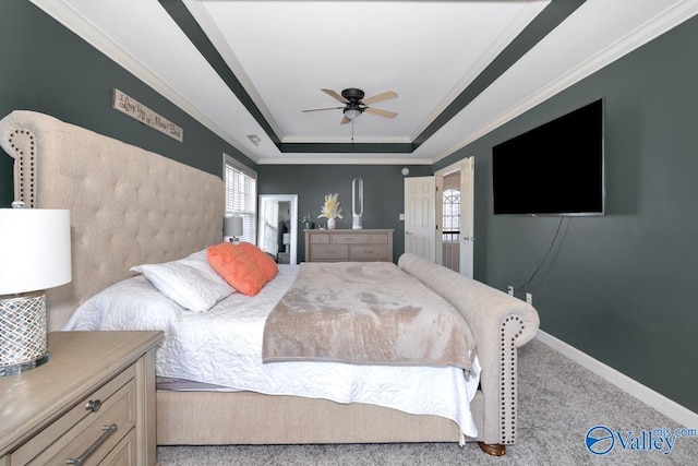 bedroom featuring a raised ceiling, carpet floors, a ceiling fan, baseboards, and ornamental molding