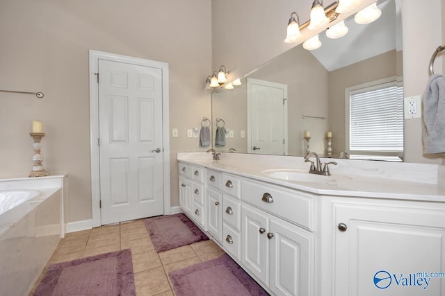bathroom featuring double vanity, a sink, tile patterned floors, baseboards, and a bathing tub