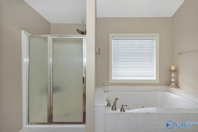 bathroom featuring a whirlpool tub and a stall shower