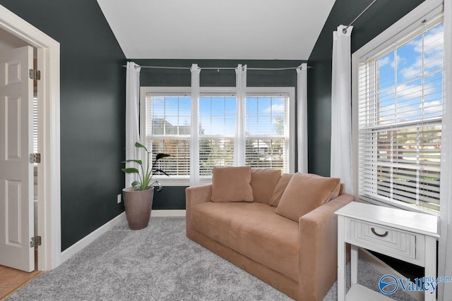 sitting room with baseboards, carpet floors, and vaulted ceiling