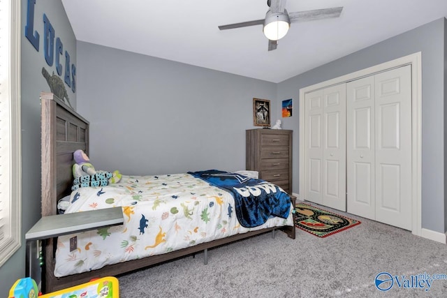 carpeted bedroom featuring baseboards, ceiling fan, and a closet