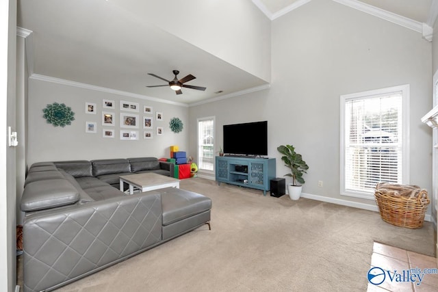 carpeted living area featuring baseboards, ceiling fan, and ornamental molding