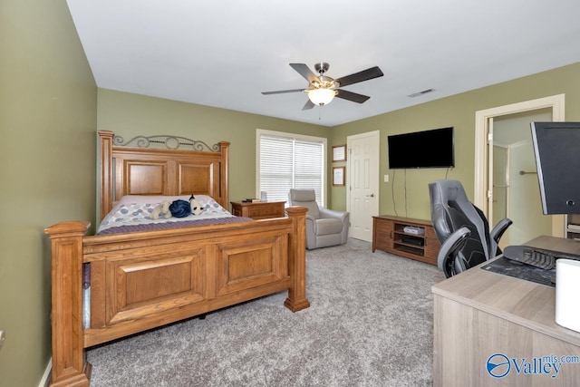 bedroom featuring a ceiling fan, light colored carpet, and visible vents