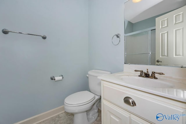 full bath with toilet, baseboards, a shower stall, and vanity