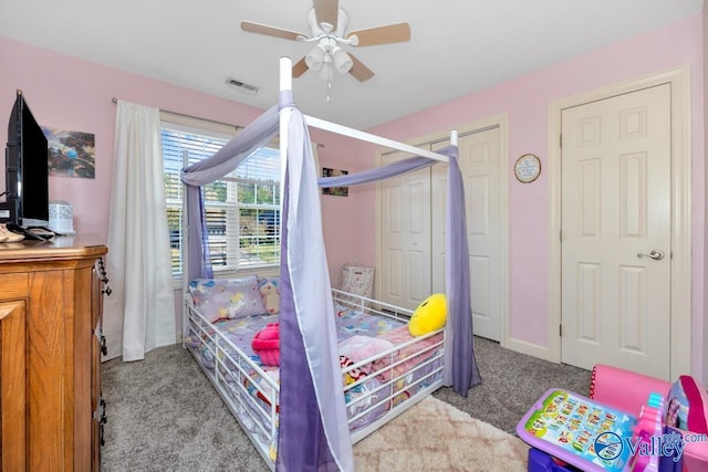 bedroom featuring visible vents, carpet, ceiling fan, and a closet