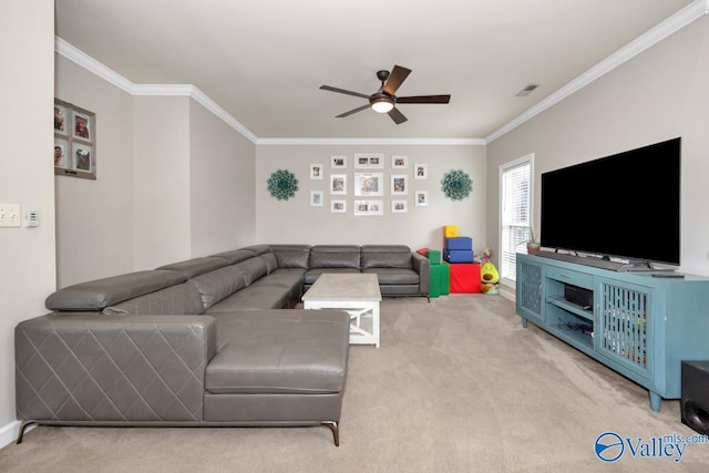 carpeted living area featuring visible vents, ornamental molding, and a ceiling fan