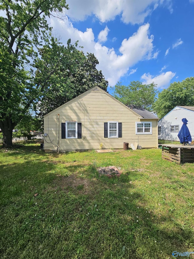 back of house with a lawn