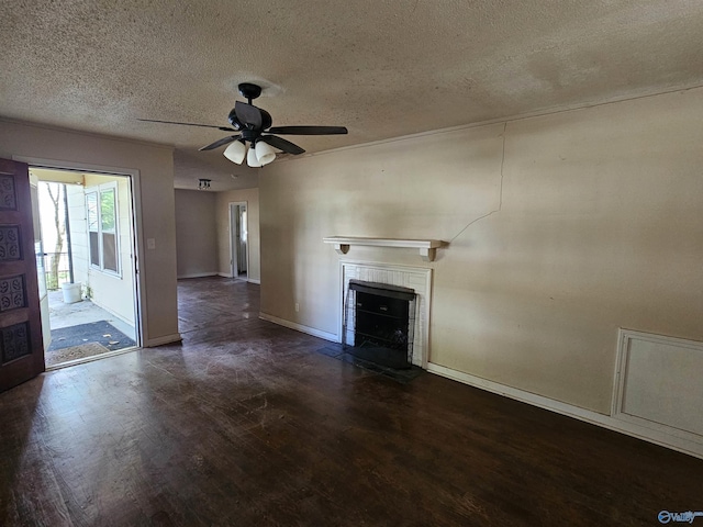 unfurnished living room with ceiling fan, a textured ceiling, a fireplace with flush hearth, wood finished floors, and baseboards