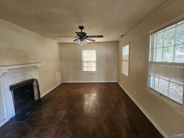 unfurnished living room featuring wood finished floors, a fireplace, baseboards, ceiling fan, and a textured ceiling