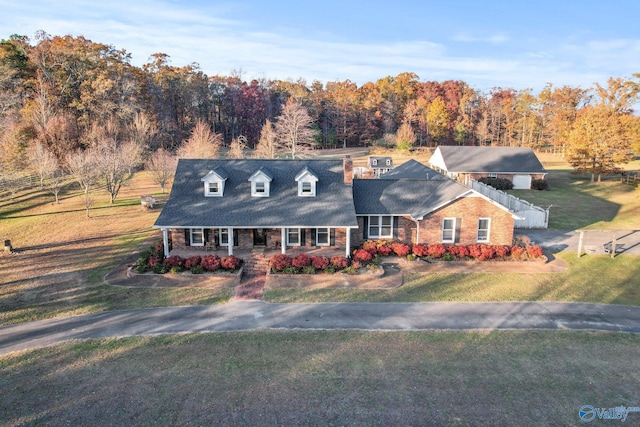 cape cod-style house featuring a front yard