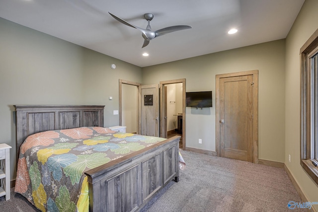 bedroom featuring ensuite bathroom, carpet floors, and ceiling fan