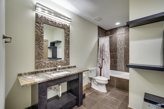 full bath featuring visible vents, toilet, tiled shower / bath combo, tile patterned flooring, and a sink