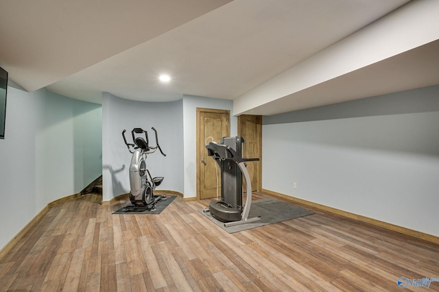 workout room featuring recessed lighting, wood finished floors, and baseboards