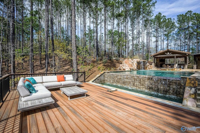 wooden terrace featuring an outdoor pool and an outdoor hangout area