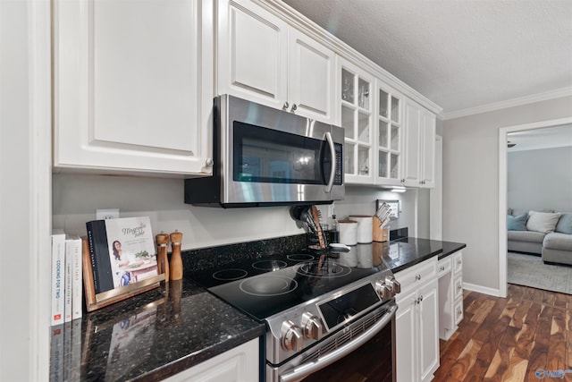 471 Oak Trl NE, Hartselle, AL 35640 - kitchen featuring appliances with stainless steel finishes, white cabinetry, glass insert cabinets, dark wood-type flooring, and crown molding