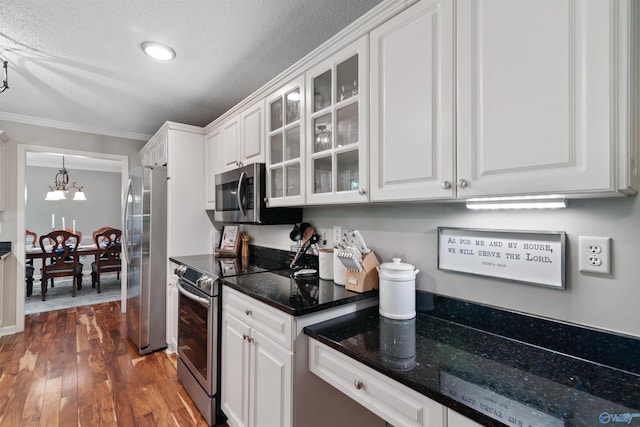 471 Oak Trl NE, Hartselle, AL 35640 - kitchen featuring appliances with stainless steel finishes, a chandelier, white cabinets, hardwood / wood-style floors, and crown molding