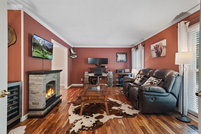 471 Oak Trl NE, Hartselle, AL 35640 - living area with wine cooler, crown molding, wood finished floors, a stone fireplace, and baseboards