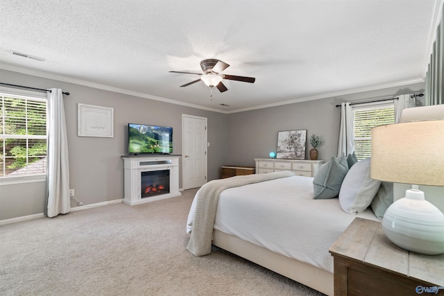 471 Oak Trl NE, Hartselle, AL 35640 - bedroom with multiple windows, a glass covered fireplace, baseboards, crown molding, and carpet