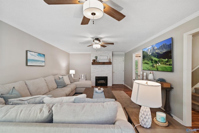 471 Oak Trl NE, Hartselle, AL 35640 - living room with wood finished floors, a ceiling fan, ornamental molding, a fireplace, and baseboards