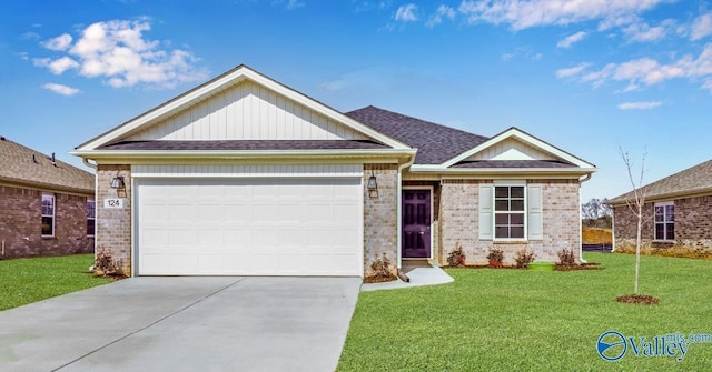 view of front of home with driveway, an attached garage, a front lawn, and brick siding