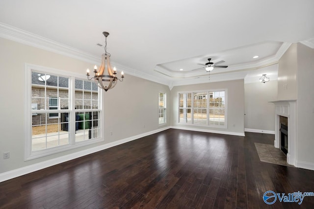 unfurnished living room featuring crown molding, dark hardwood / wood-style flooring, and a raised ceiling