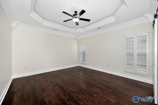 unfurnished room featuring crown molding, dark hardwood / wood-style floors, a raised ceiling, and ceiling fan