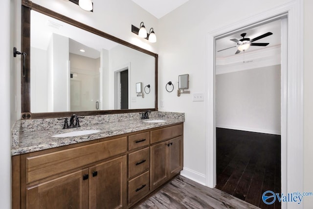 bathroom with hardwood / wood-style flooring, ceiling fan, vanity, and crown molding