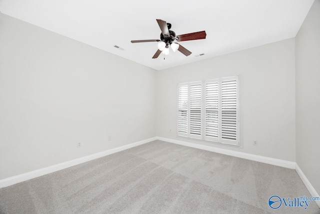 spare room featuring carpet floors and ceiling fan