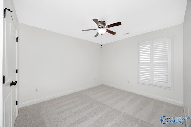 carpeted empty room featuring ceiling fan