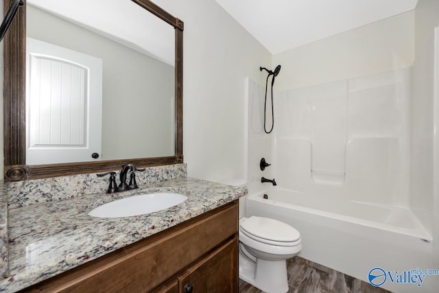 full bathroom with vanity, wood-type flooring, bathtub / shower combination, and toilet