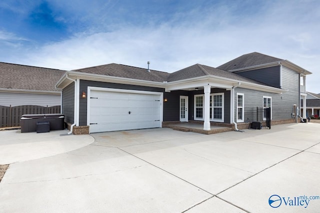 view of front of property featuring a hot tub and a garage