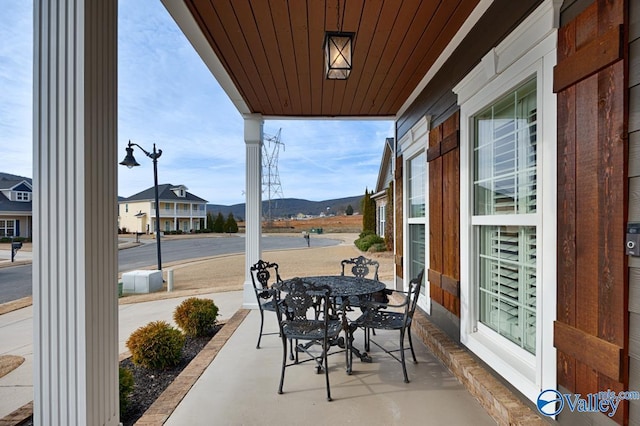 view of patio / terrace featuring a mountain view and a porch