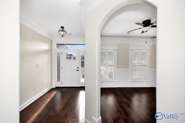 foyer with ornamental molding, dark hardwood / wood-style floors, and ceiling fan