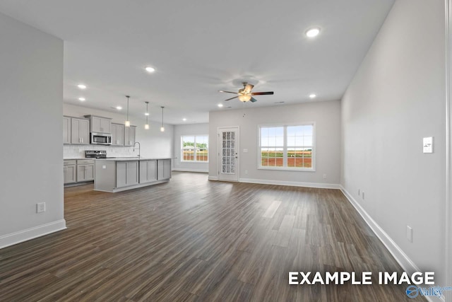 2000 Austin Dr NE, Cullman, AL 35058 - unfurnished living room featuring a sink, baseboards, ceiling fan, and recessed lighting