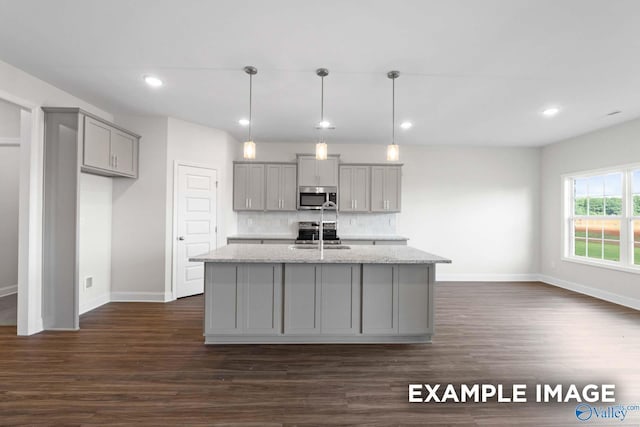 2000 Austin Dr NE, Cullman, AL 35058 - kitchen featuring a kitchen island with sink, gray cabinetry, decorative backsplash, appliances with stainless steel finishes, and dark wood-style flooring