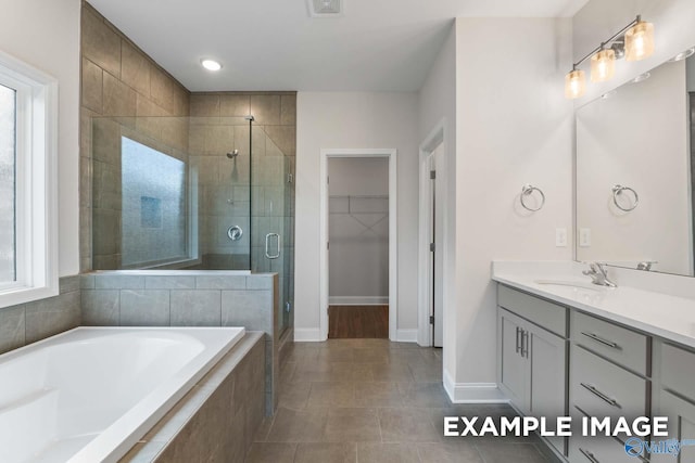 2000 Austin Dr NE, Cullman, AL 35058 - bathroom with a spacious closet, a shower stall, baseboards, a bath, and vanity