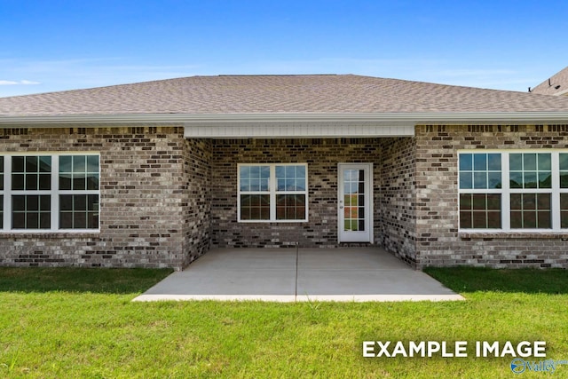 2000 Austin Dr NE, Cullman, AL 35058 - exterior space featuring a patio area, a lawn, brick siding, and a shingled roof