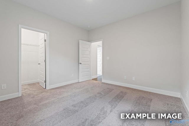 2000 Austin Dr NE, Cullman, AL 35058 - unfurnished bedroom featuring a spacious closet, carpet, and baseboards