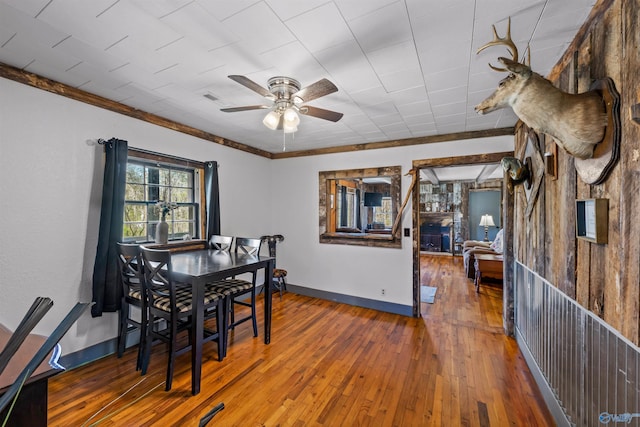 dining space featuring wood-type flooring and ceiling fan