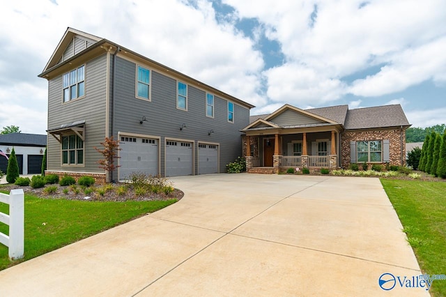 craftsman inspired home featuring a front yard and a garage